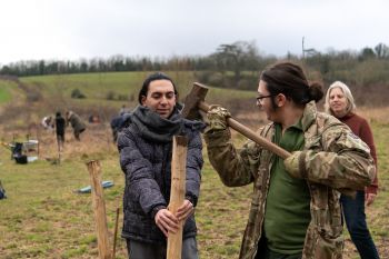 Staff volunteers work with students to plant the forest food garden (1)