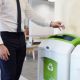 White man putting plastic bottle in recycling bin