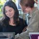 Two young female students looking at a laptop