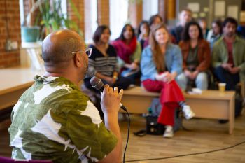 An attendee speaks to the audience