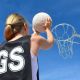 A netball player takes a shot