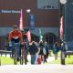 A young man rides his bike on campus