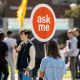 Student volunteer holding Ask Me sign during Welcome Week