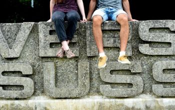 close-up of the famous Sussex sign with two students