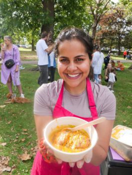 Woman holding box of potato chaat street food