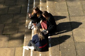 Students chatting and sitting on steps