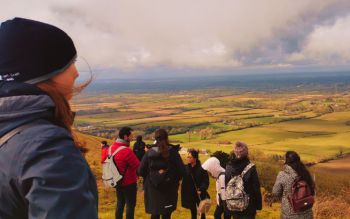 Group of students overlooking the South Downs on a cold and cloudy day
