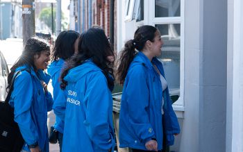 Community Ambassadors talking to someone on their doorstep