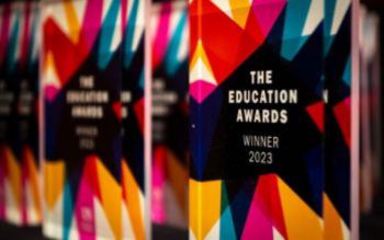 A line of colourful Education Awards trophies
