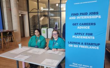 Two careers staff members hosting the summer jobs fair