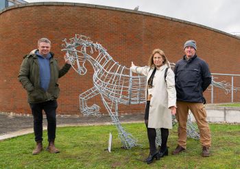 A horse sculpture with the artist (left) and members of staff