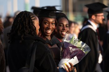 Graduates smiling in their gowns