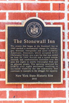 The plaque on the wall of Stonewall Inn with a description of the riot that happened there.