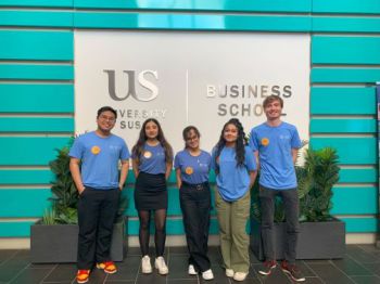 student wellbeing mentors standing inside Jubilee foyer, wearing blue mentor t-shirts