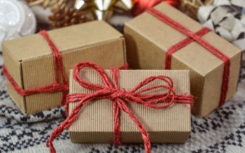 Three little cardboard boxes tied with red thread