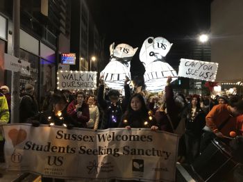 Sussex students carry their paper lantern sculptures at the Burning of the Clocks parade