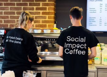 Arts Piazza baristas serving Social Impact Coffee