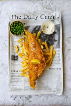 Tasty-looking fish and chips on newspaper saying 'The Daily Catch'