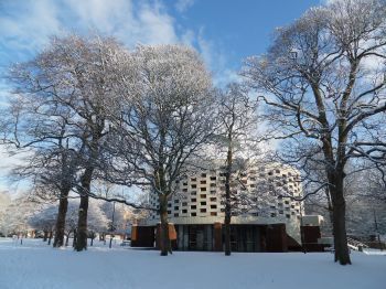 Sussex University Meeting House, blue skies and trees covered in snow.