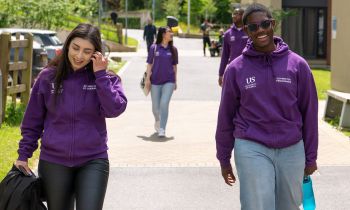 Residential Life Connectors in their purple uniforms walking through campus