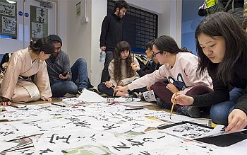 Students taking part in a calligraphy event as part of One World Week