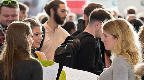 Two students talking with an employer at Careers Fair
