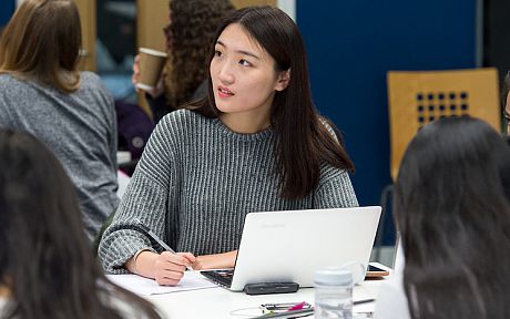 Student taking notes in seminar