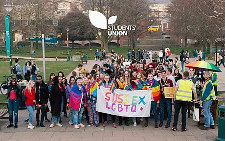 Students in Library Square holding LGBTQ banner