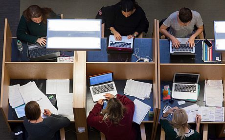 Students working at library desks