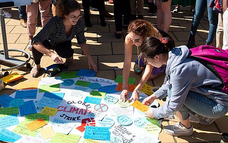 Staff and students working on a climate change poster