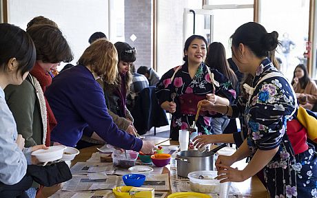 Students and staff doing Japanese calligraphy