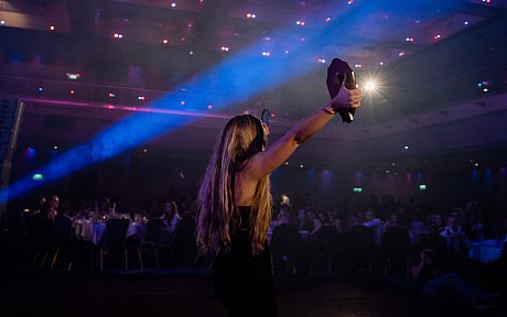 Student holding up award