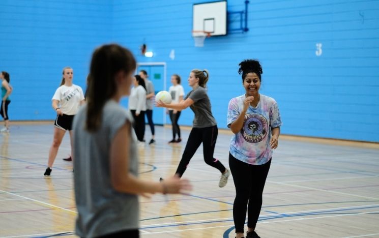 Female students playing netball at the Sport Centre