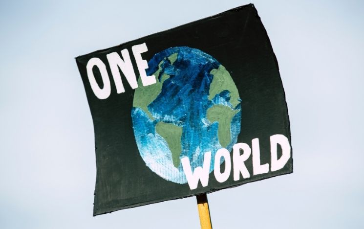 A banner with planet Earth and message ONE WORLD