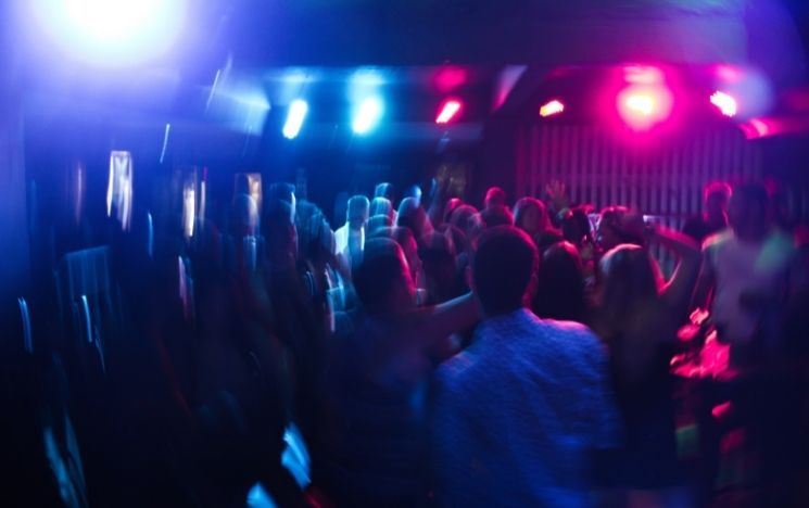 Blurry image of people dancing in a club