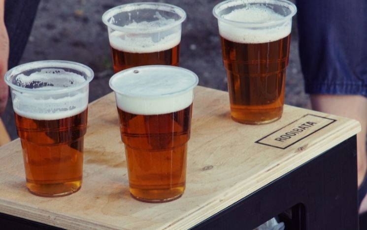 Four pints of beer on a wooden table