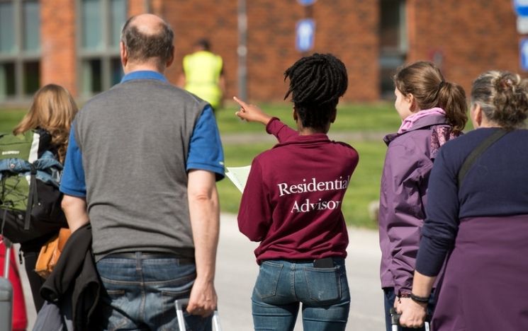 student ambassador showing visitors around campus