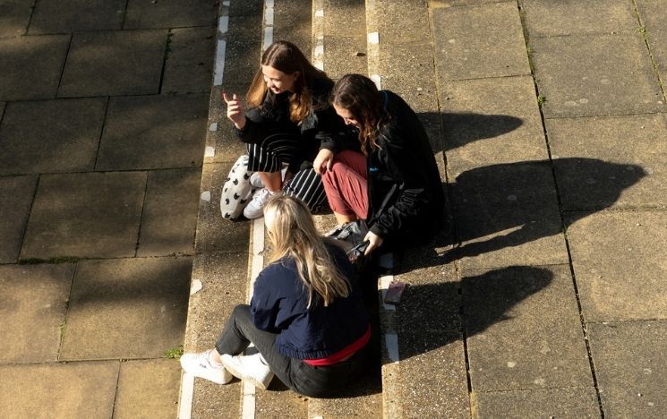 students relaxing on the steps to Chichester lecture theatre