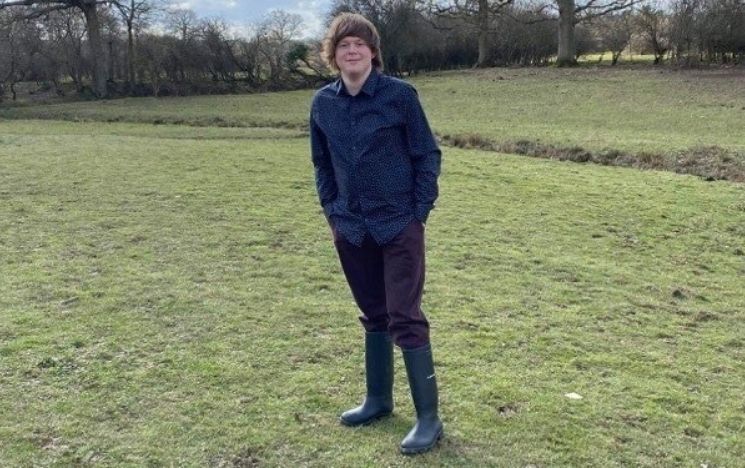 Biology student James on a field