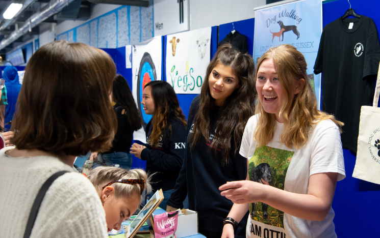 Members of the Dog Walking Society talk to freshers at Freshers Fair