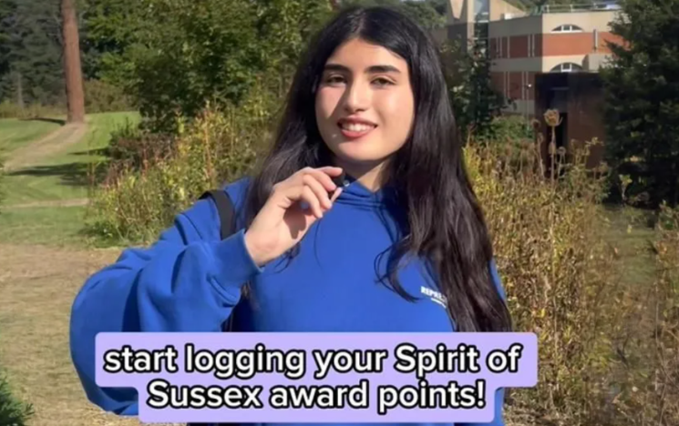 DMC Sabrina speaks to camera and the text underneath says Start logging your Spirit of Sussex Award points