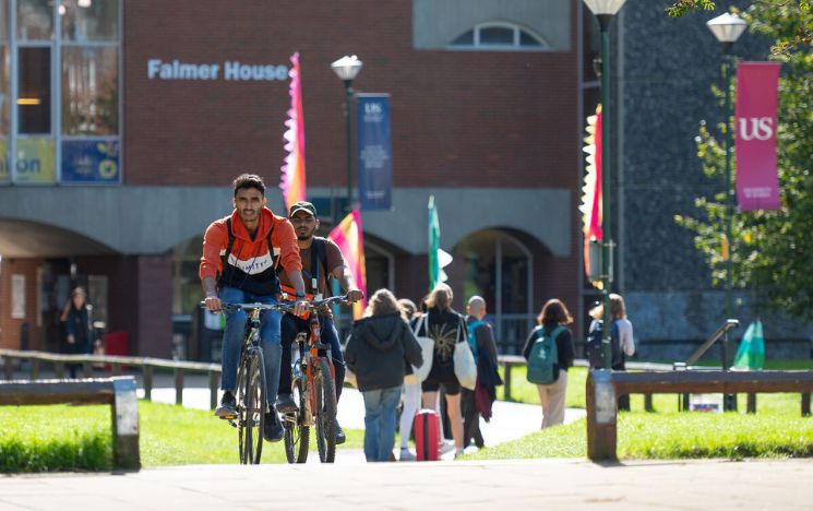 Students moving around campus on their bikes