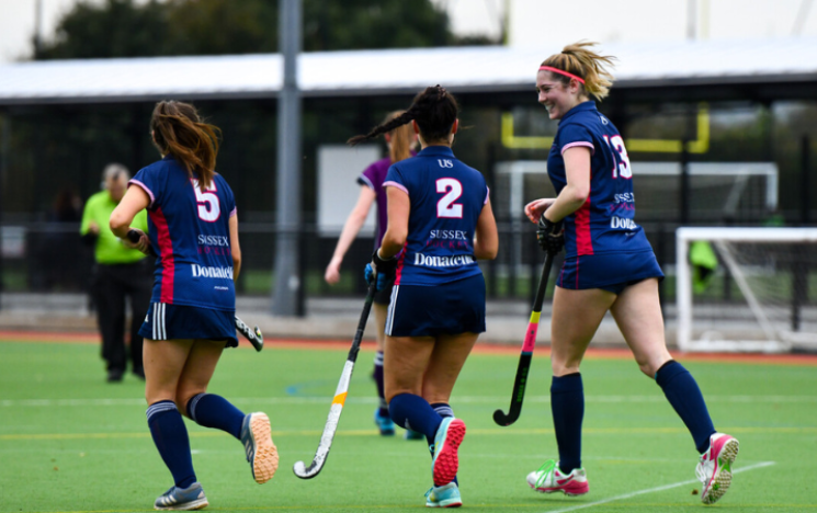 Students in University of Sussex kits play hockey