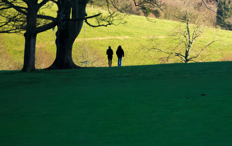 Two students walking in Stanmer Park