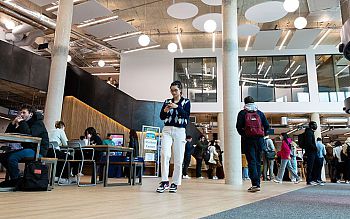 The foyer of the Student Centre with daylight flooding in as students move around busily inside the space