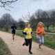 Two women running in the South Downs. One of them is wearing a Sussex yellow jersey