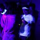 Students glowing under UV light in the Sports Centre