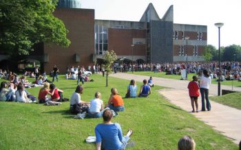Students sitting on the grass on campus