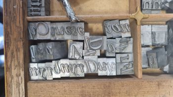 A wooden case full of metal letters for a letterpress